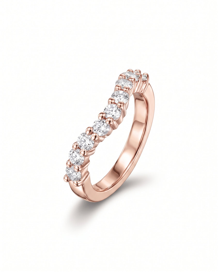 Rose gold curved wedding ring featuring a row of round cut diamonds in claw settings.