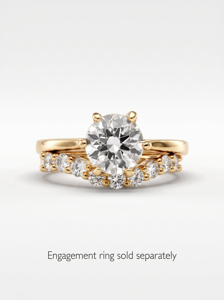 Gold wedding band featuring a curved row of round cut diamonds in a claw setting.