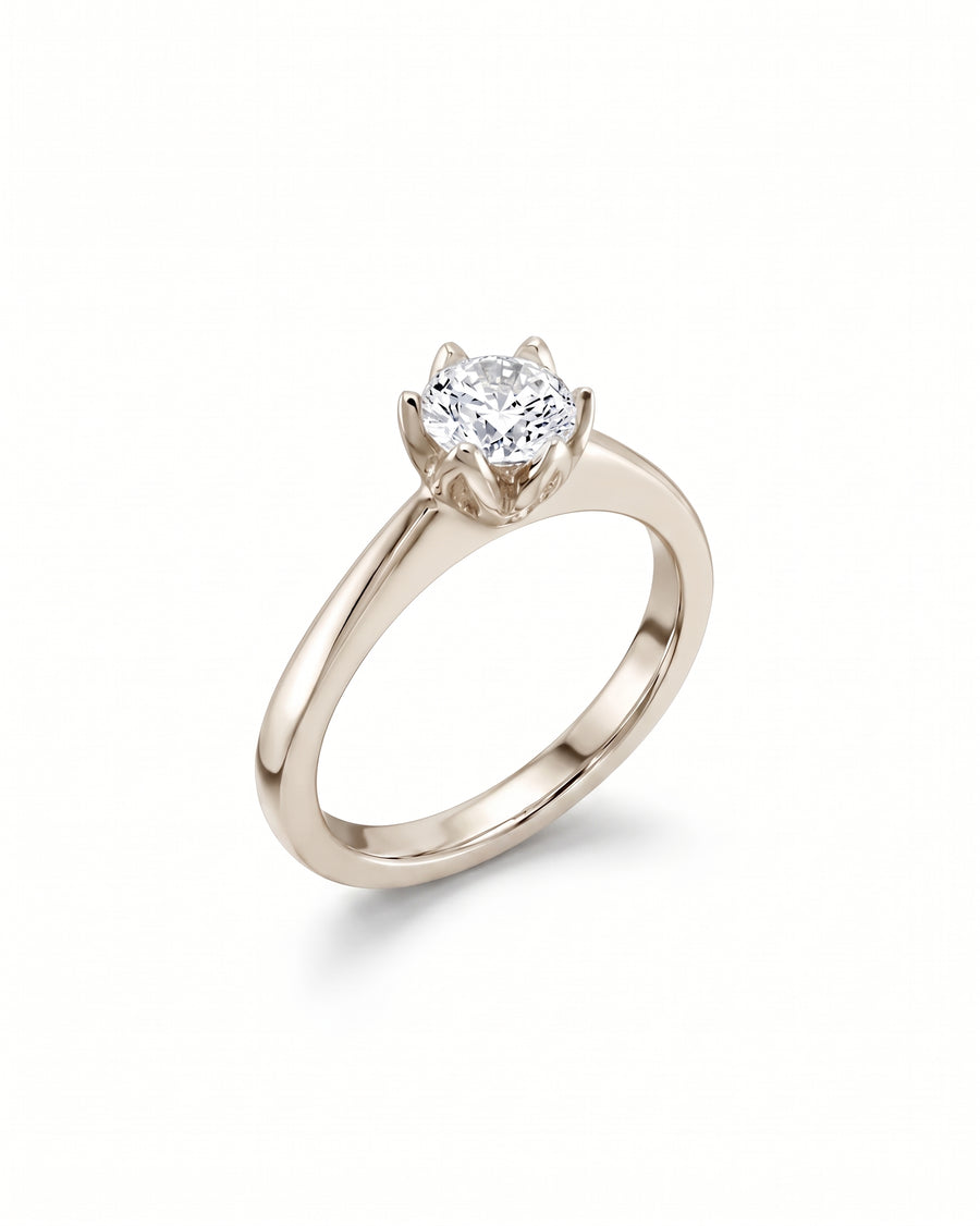 Round brilliant diamond engagement ring in a six-claw platinum setting on a polished band.