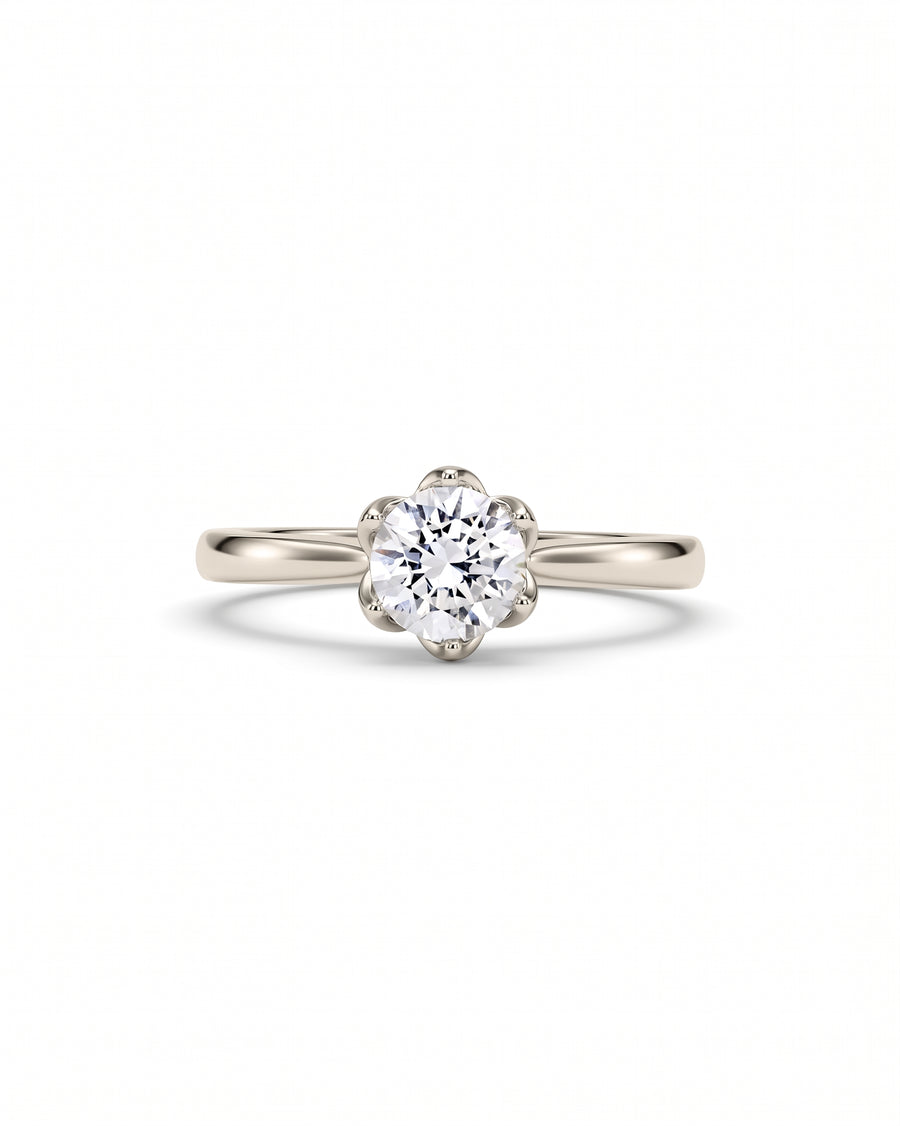 Round brilliant diamond engagement ring in a platinum claw setting with a polished band.