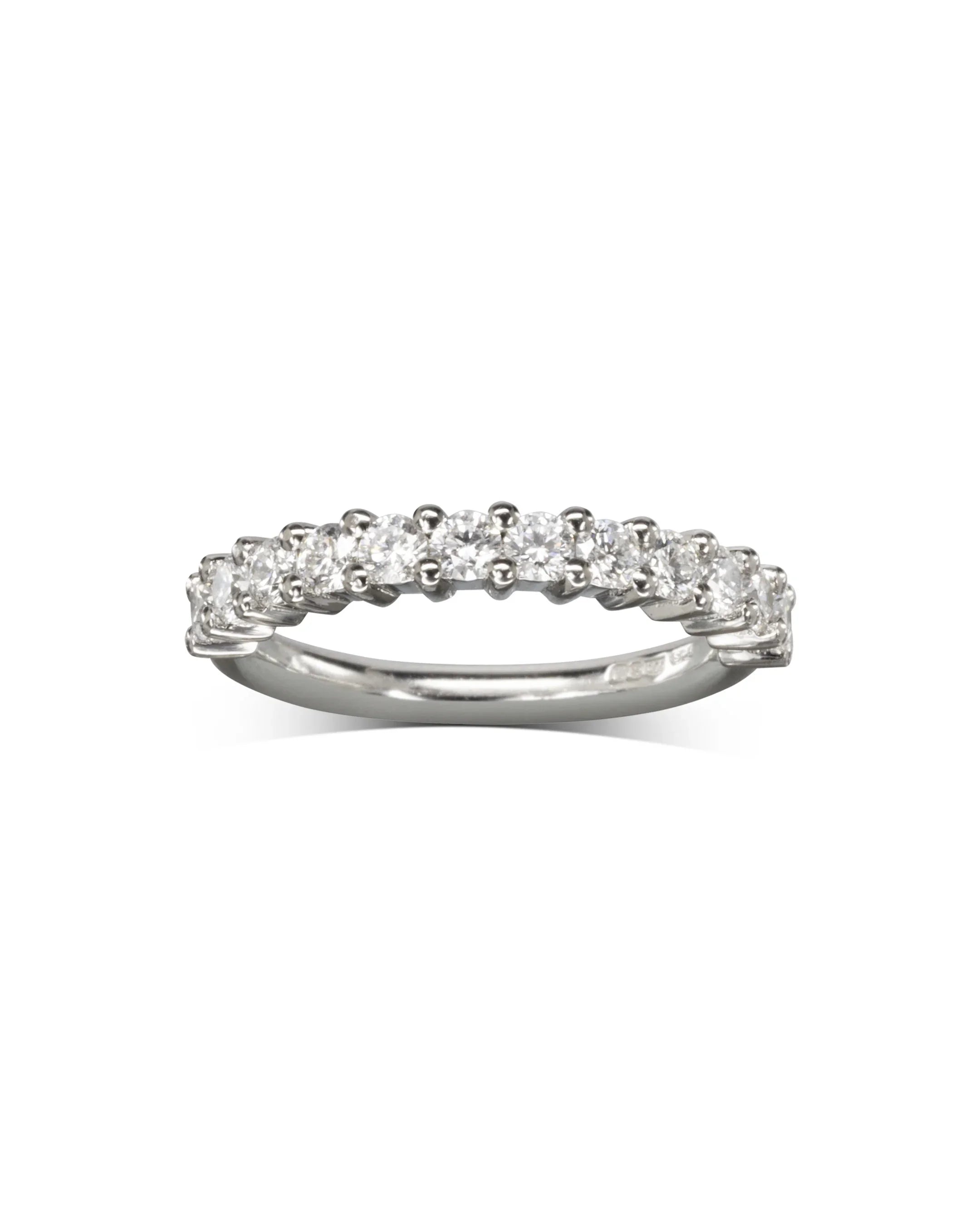 Platinum half eternity ring with claw-set round diamonds on a polished band