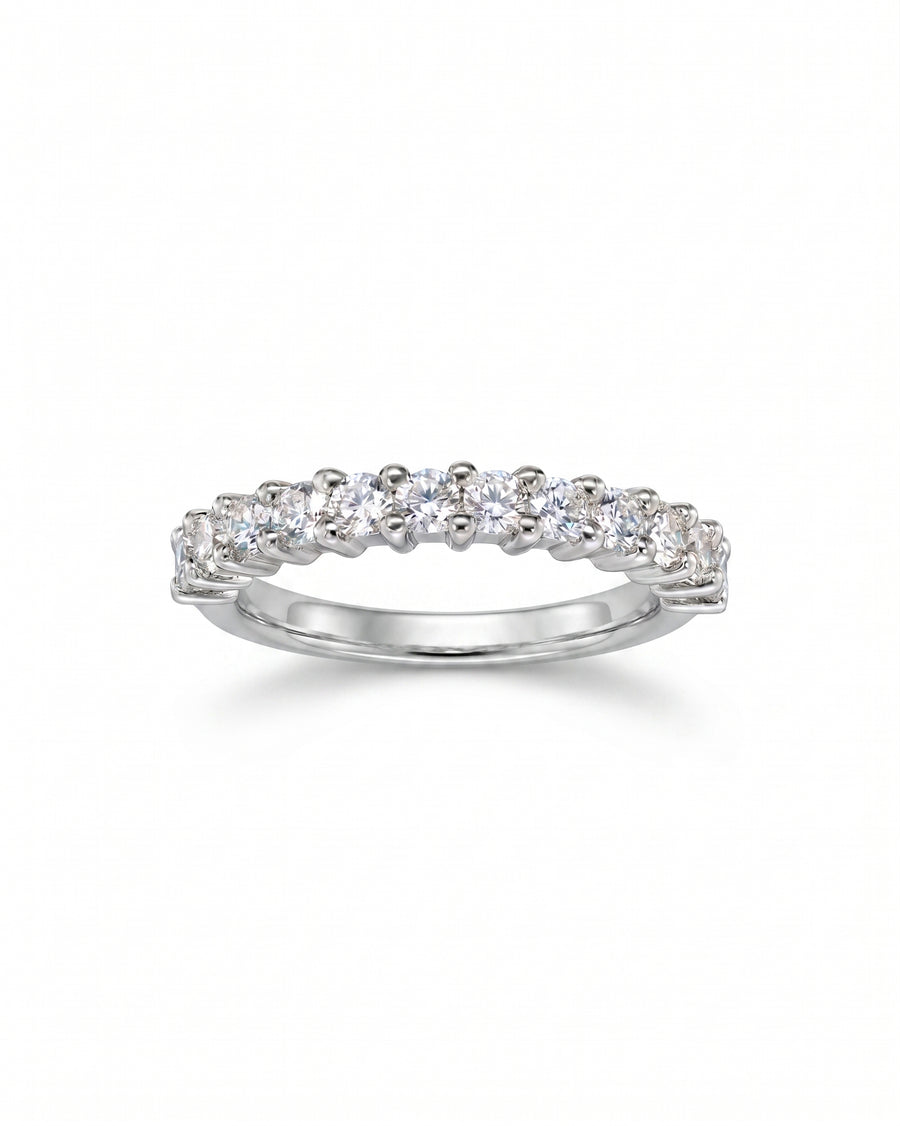 White gold half eternity ring with claw set round diamonds.