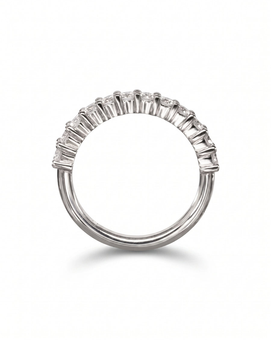 Silver claw set diamond half eternity ring.