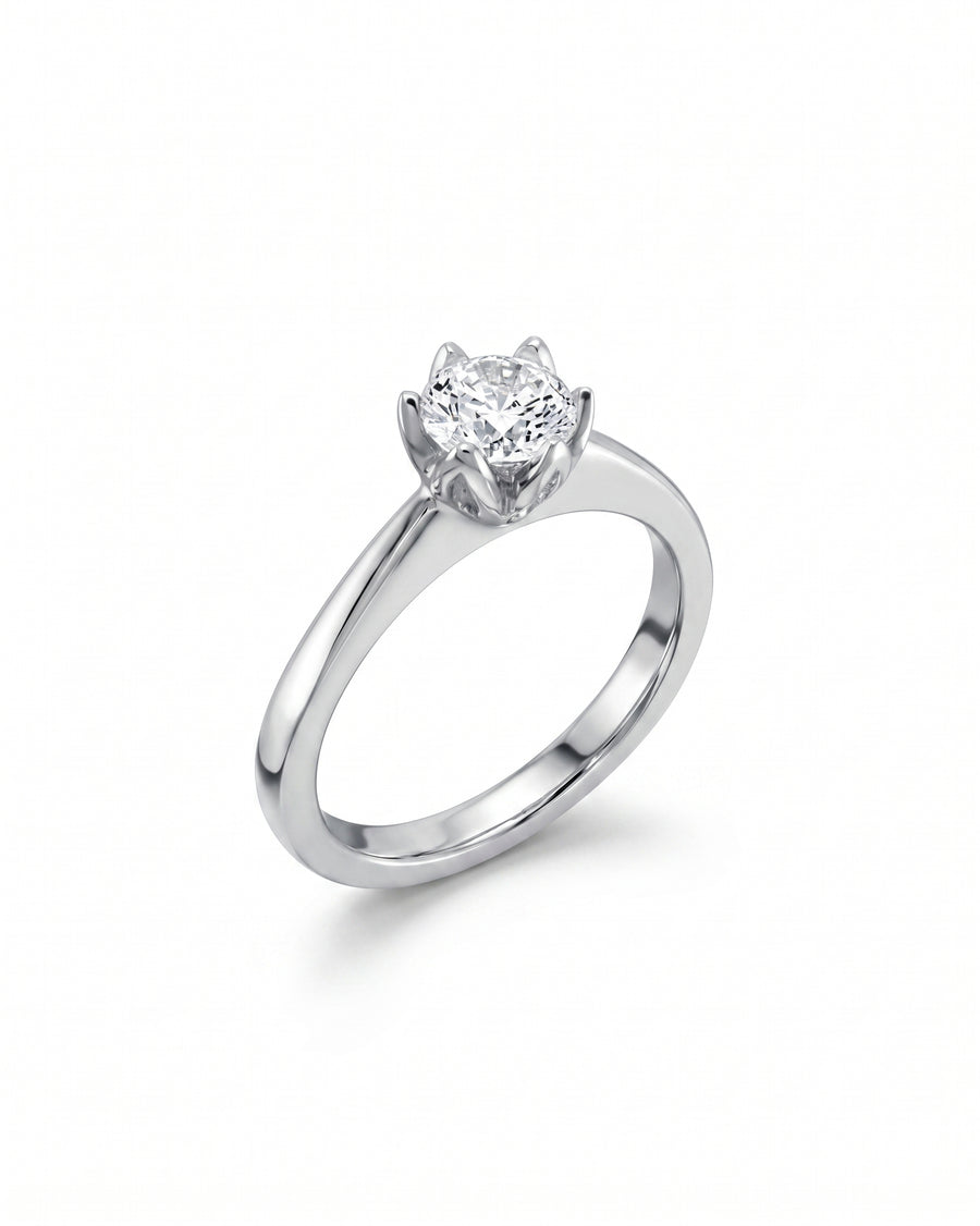 Platinum engagement ring with a round, claw-set diamond.