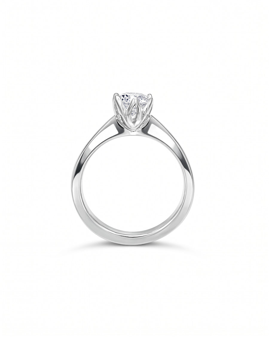 Claw set diamond platinum engagement ring with a round brilliant cut diamond.