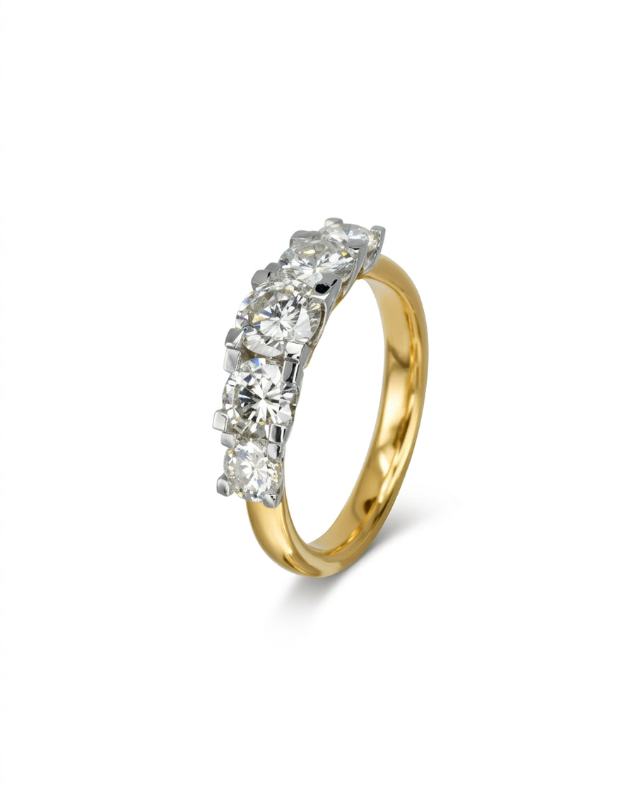 Gold eternity ring with five claw-set round diamonds.