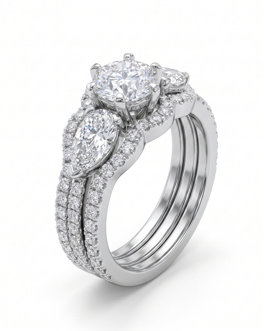 White gold trilogy ring set with round brilliant and pear shaped diamonds.