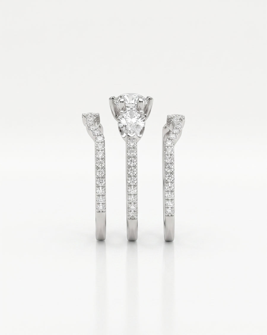 White gold trilogy ring set with round brilliant and pear shaped diamonds.
