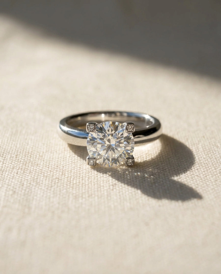 Silver claw set round brilliant diamond engagement ring.