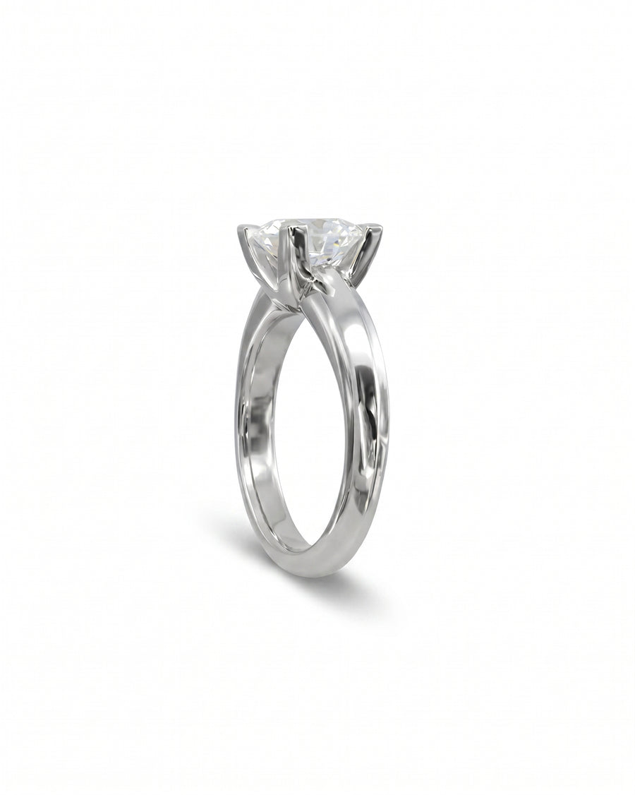 Silver claw set round brilliant diamond engagement ring.