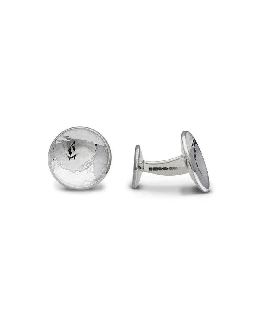 Round silver cufflinks with a concave, textured surface and polished metal finish.