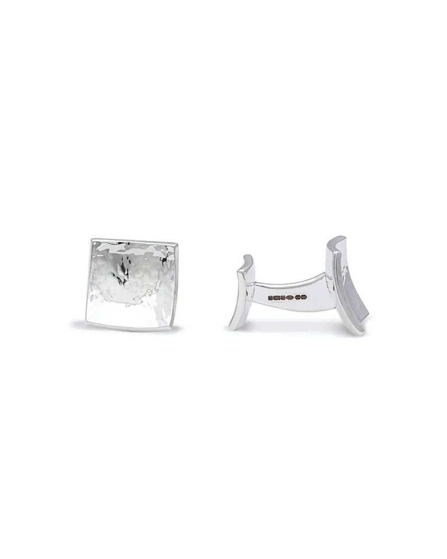Square silver cufflinks with a polished, concave surface and a hammered texture finish.