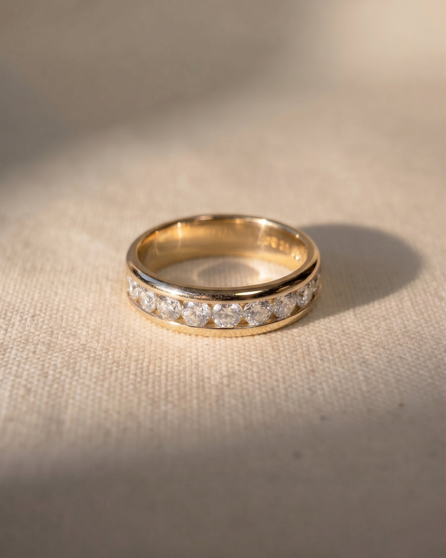 18ct yellow gold court ring with channel-set round brilliant cut diamonds.
