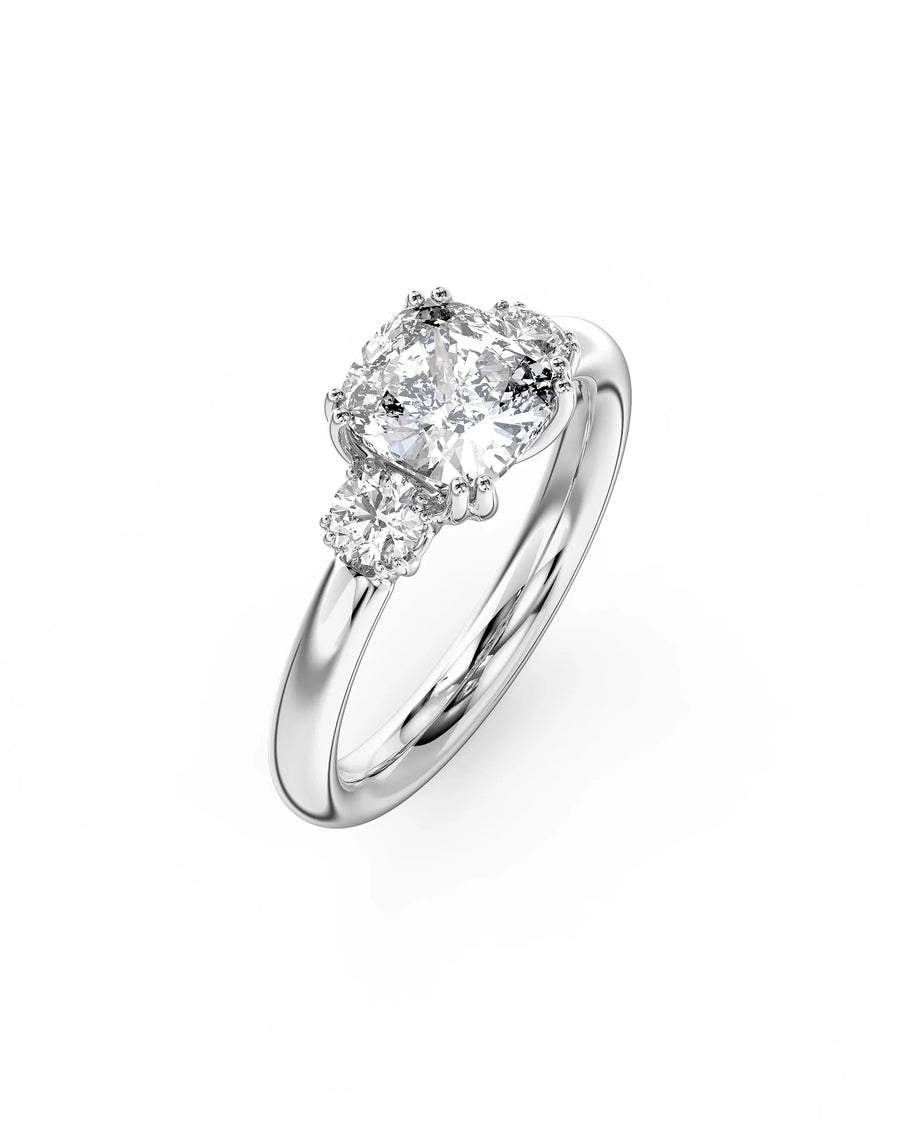 Platinum cushion cut trilogy engagement ring with three diamonds.