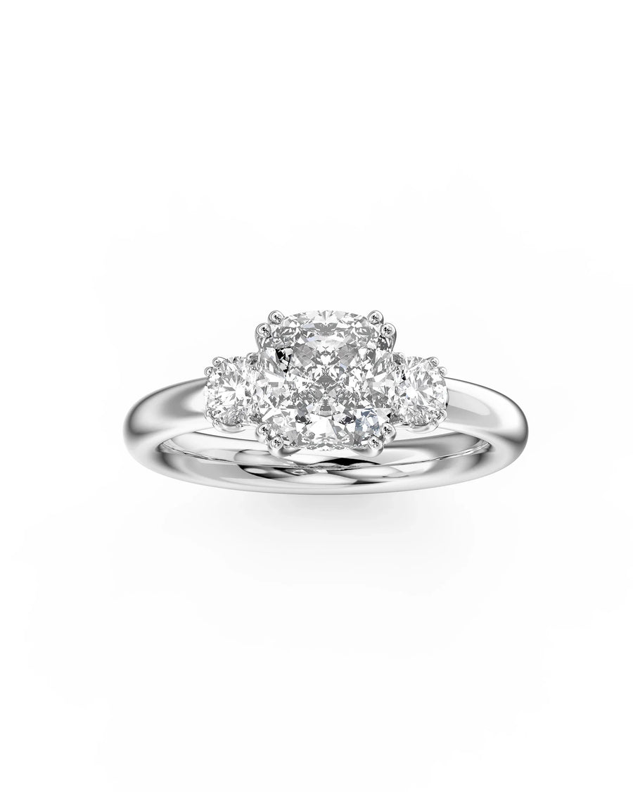 Silver cushion cut trilogy engagement ring with three diamonds.