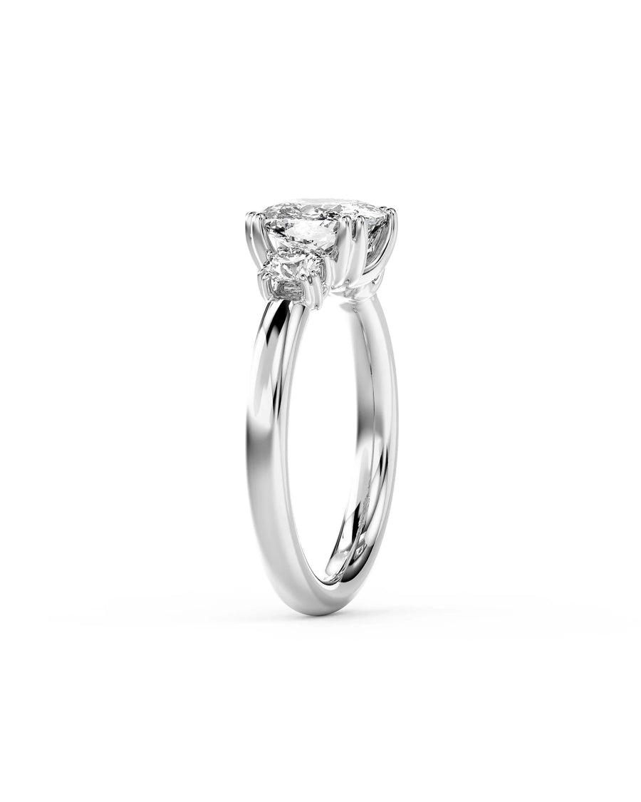Silver cushion cut trilogy engagement ring with three diamonds.