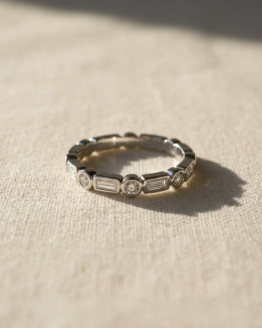 9ct white gold half set eternity ring with alternating baguette and round diamonds.