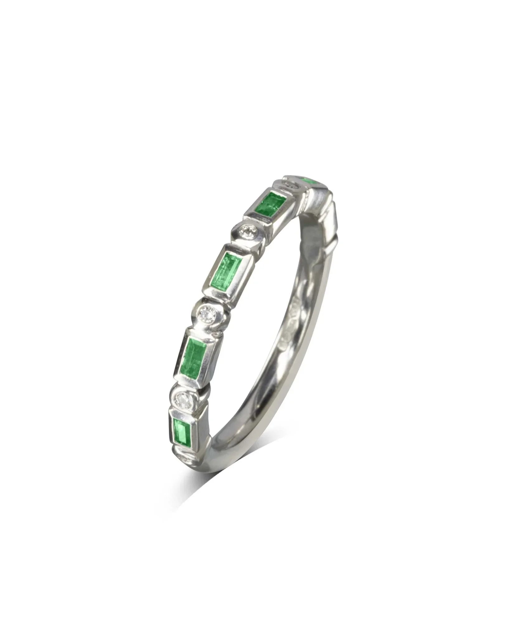 White gold eternity ring with baguette green gemstones and round diamonds
