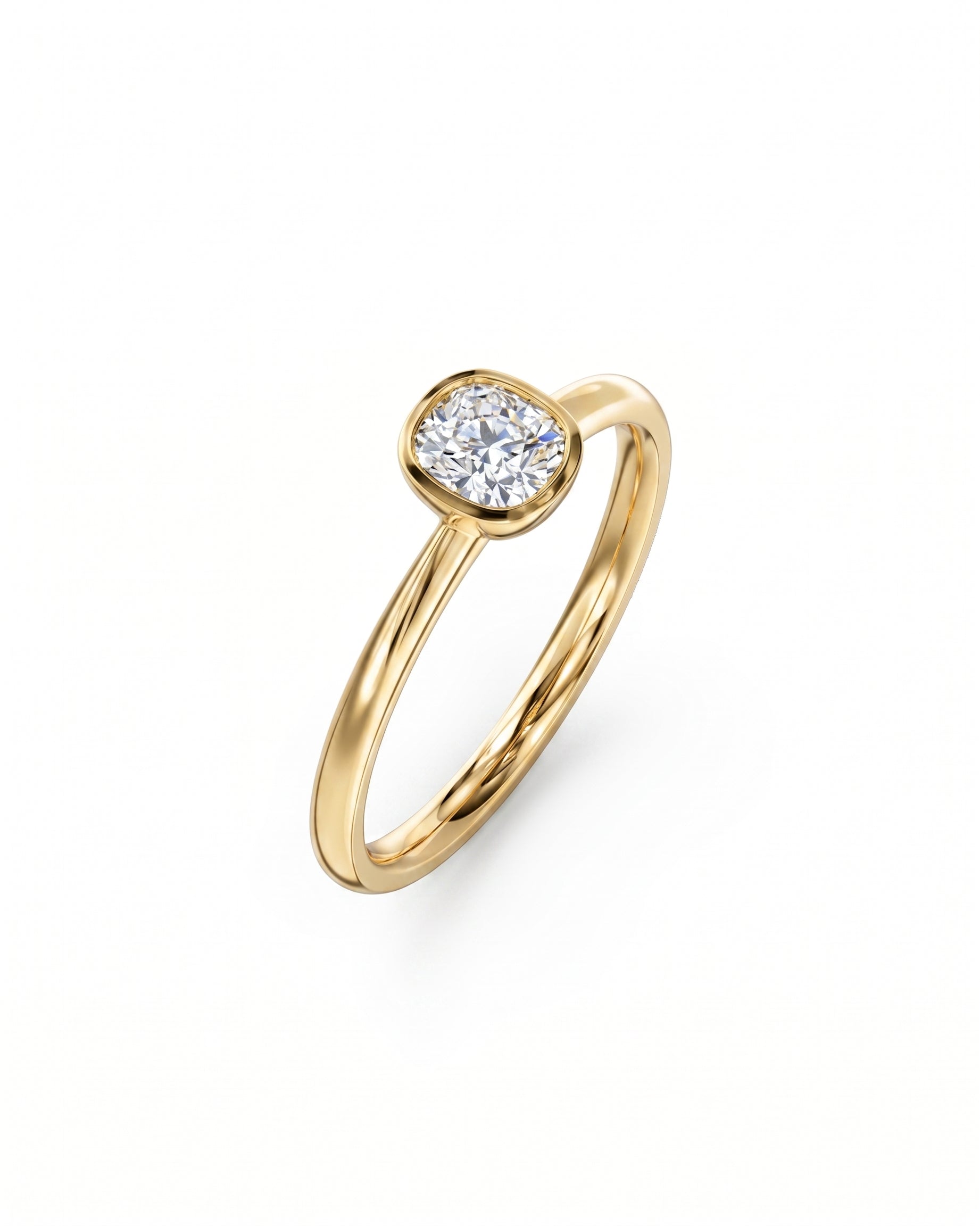 Gold engagement ring with a cushion cut diamond in a bezel setting.
