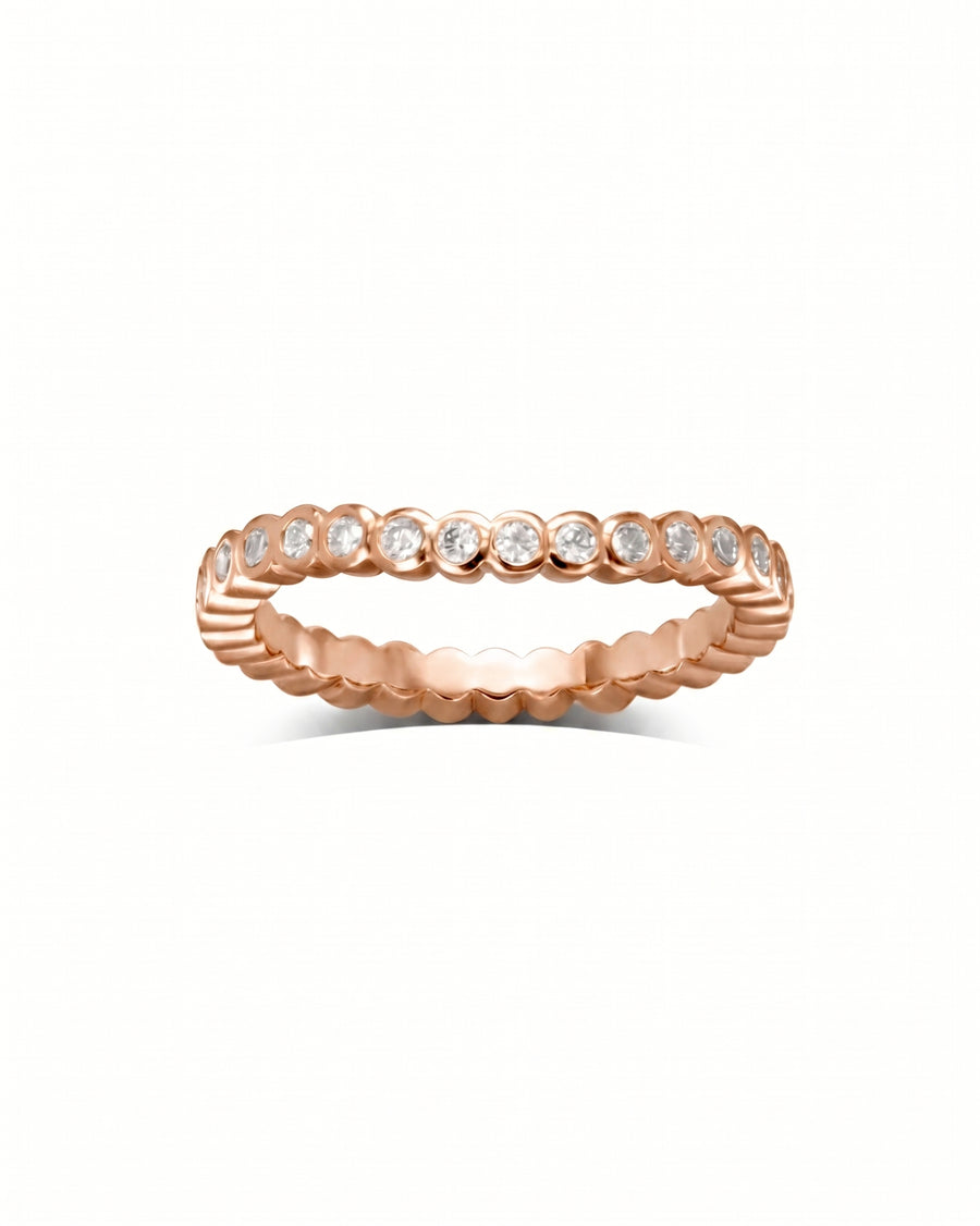 18ct rose gold wedding band with dainty round diamonds in a bezel setting.