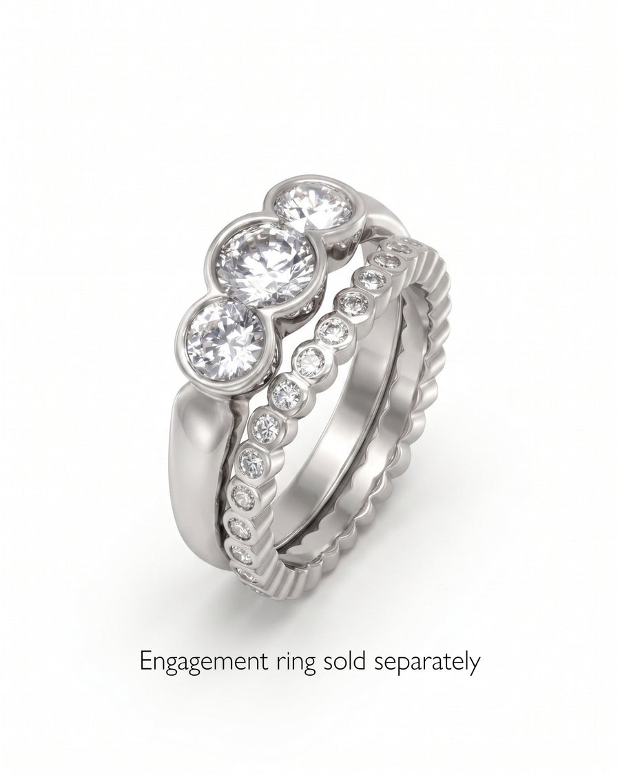 Silver wedding band with three round diamonds and a matching diamond-studded band.