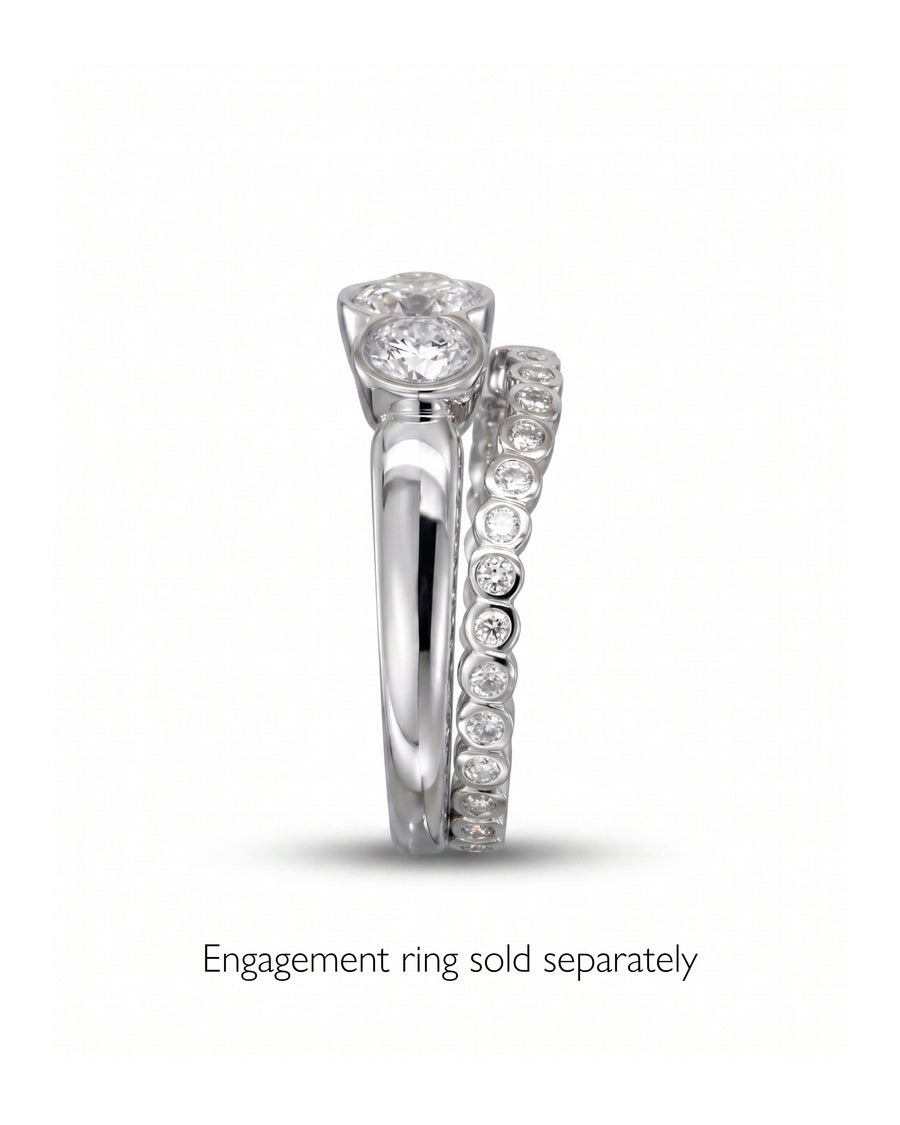 Silver diamond-shaped wedding band with round diamonds.