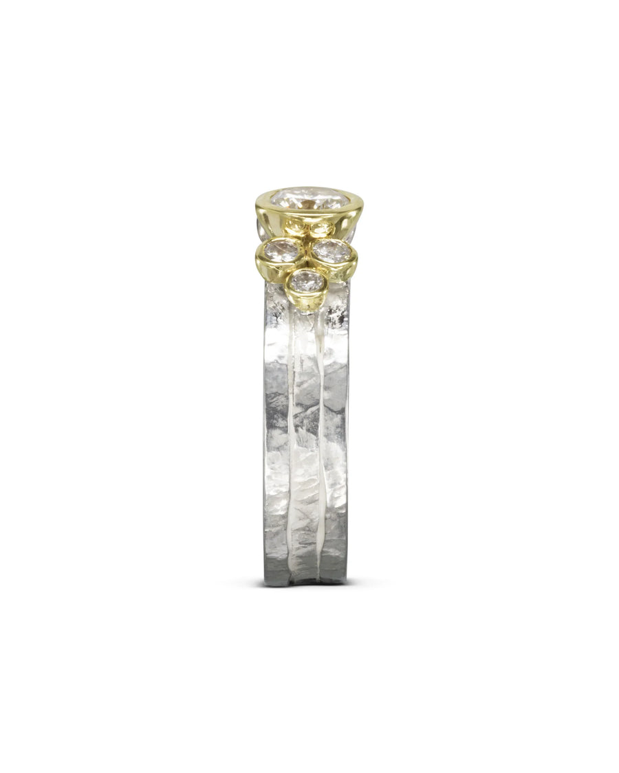 Rough hammered silver and gold stacking ring set with round diamonds.