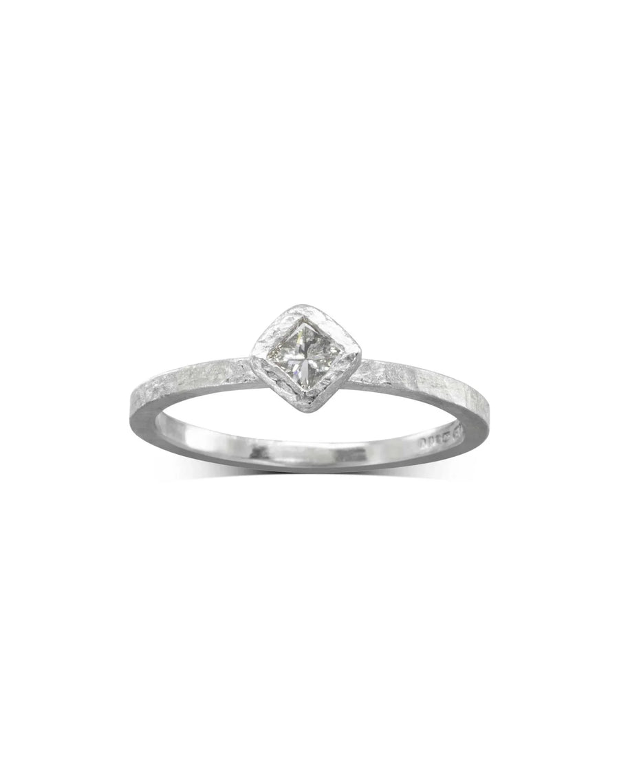 Dainty rough hammered silver ring with a square-cut diamond.