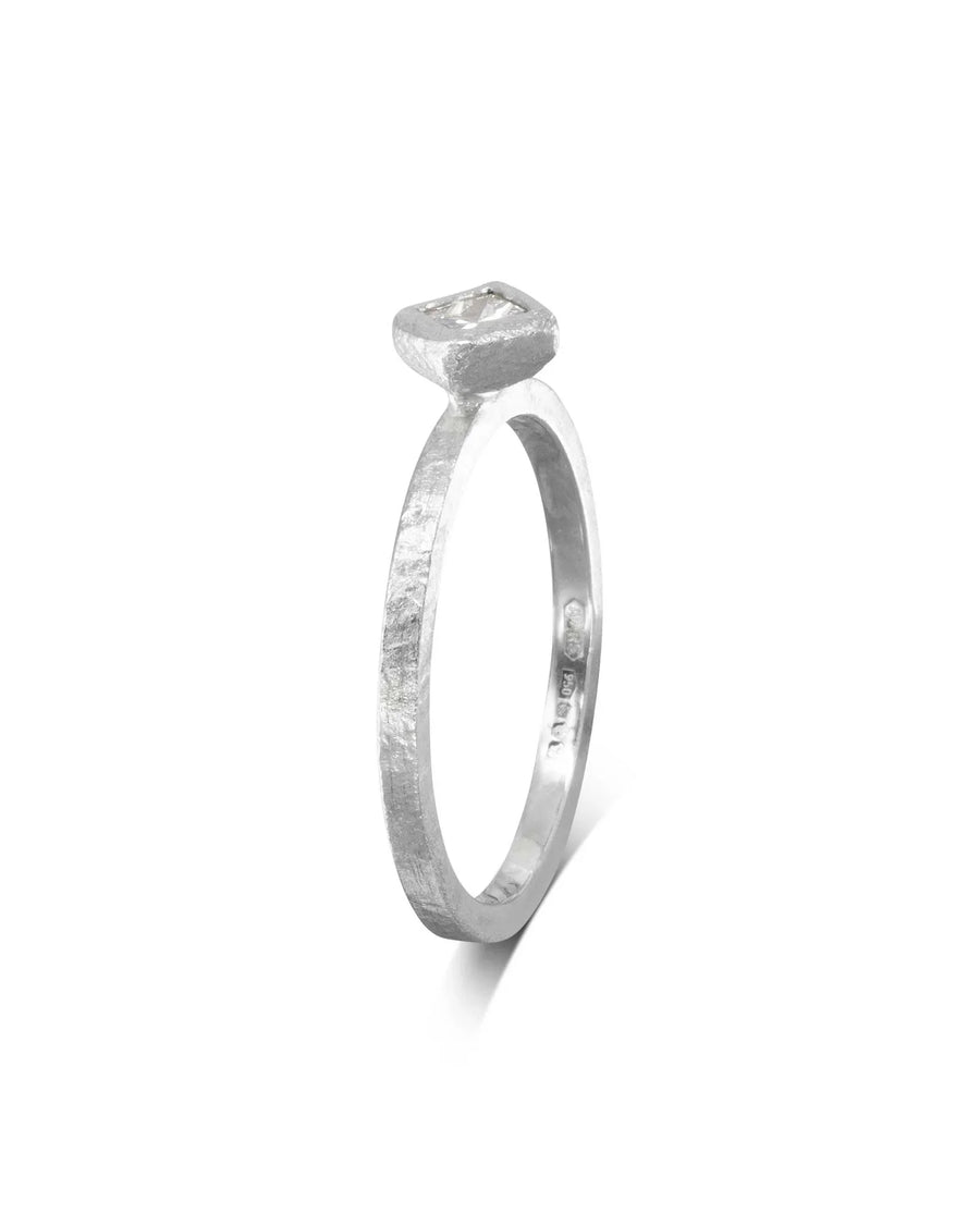 Dainty rough hammered silver engagement ring with a square diamond.