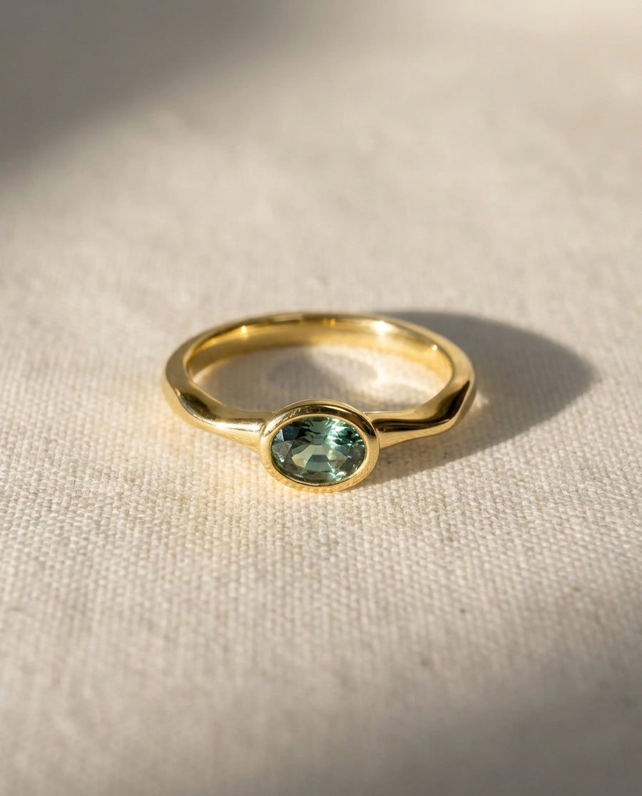 18ct yellow gold engagement ring with an oval sapphire.