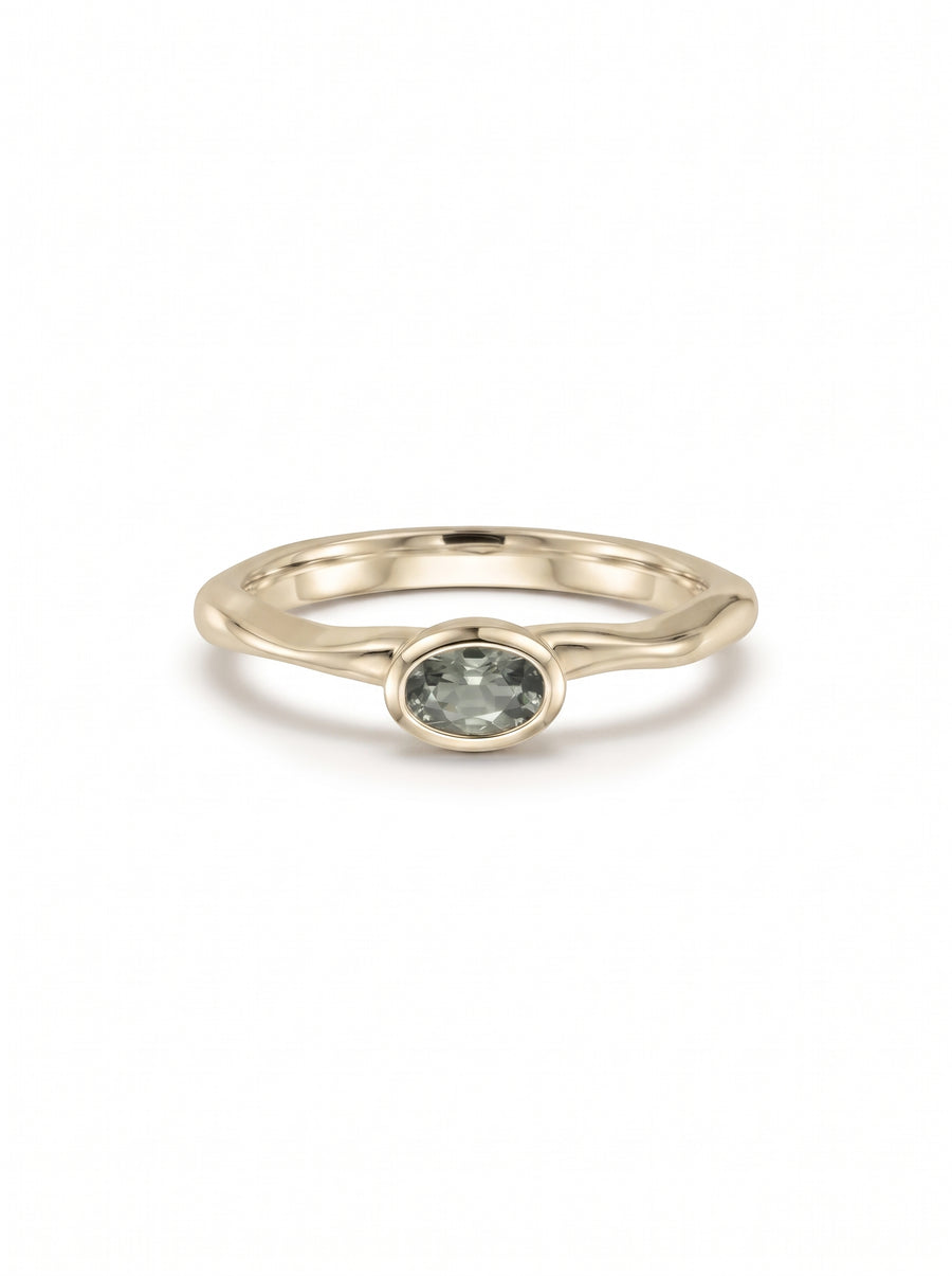 Oval green sapphire engagement ring set in a polished 9ct white gold band with a bezel setting.
