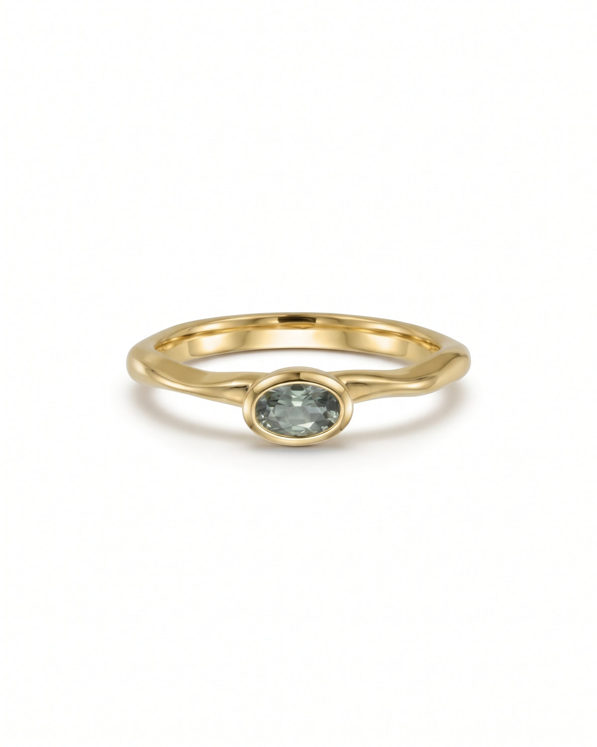 Oval green sapphire engagement ring in 9ct yellow gold with a smooth bezel setting.