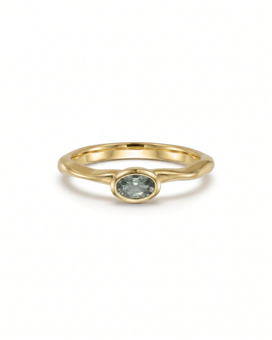 Oval green sapphire engagement ring in 9ct yellow gold with a smooth bezel setting.