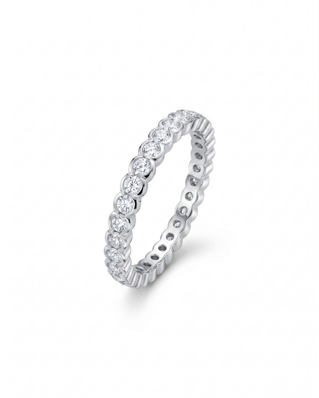 White gold eternity ring with scalloped edge diamonds.