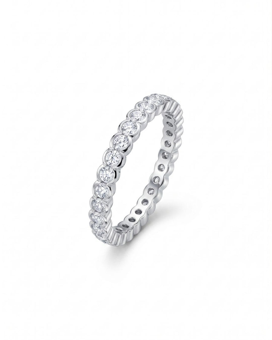 White gold eternity ring with scalloped edge diamonds.