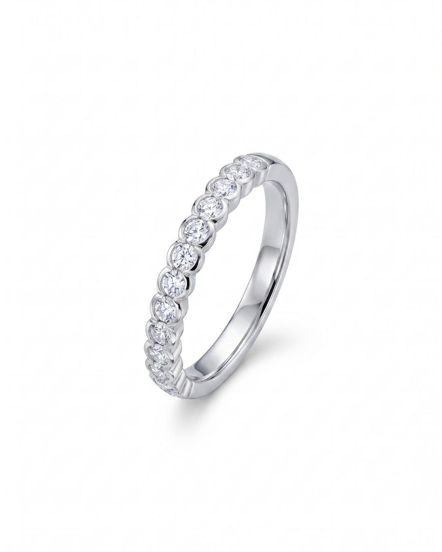 White gold ring with dainty scalloped edge diamonds.