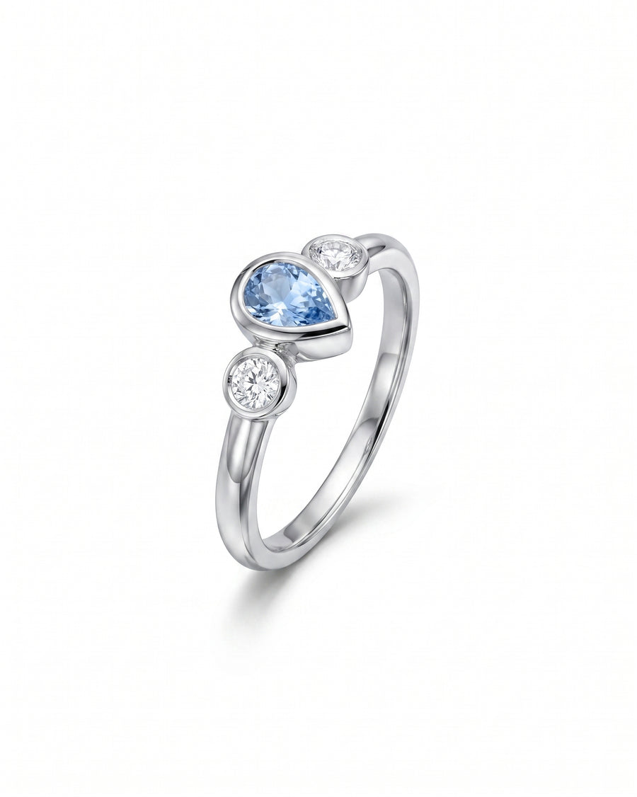 Silver ring with pear-shaped aquamarine and two round diamonds.