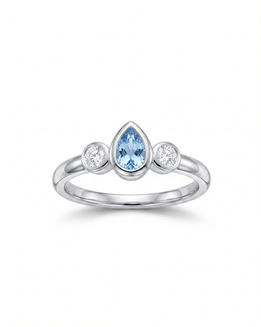 Silver ring with a pear-shaped aquamarine and two round diamonds.