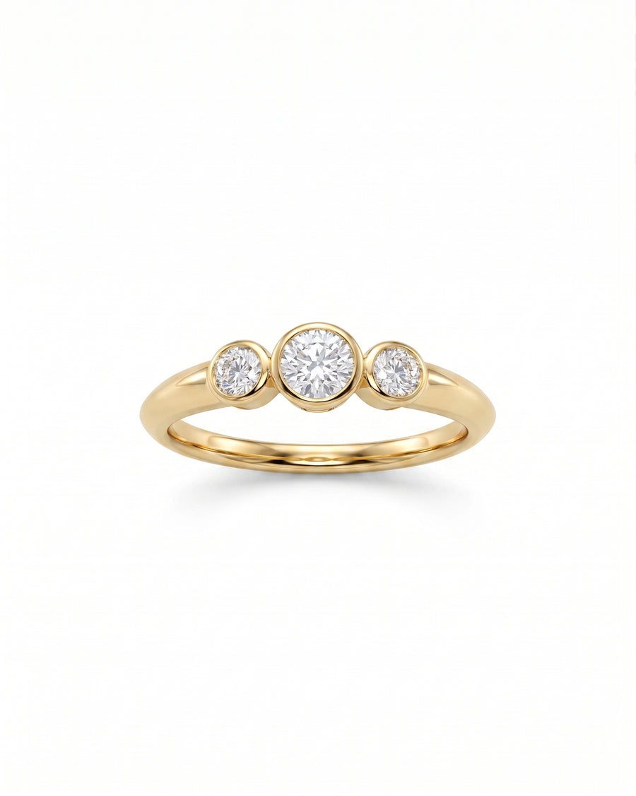 9ct gold trilogy ring with three round bezel-set diamonds.