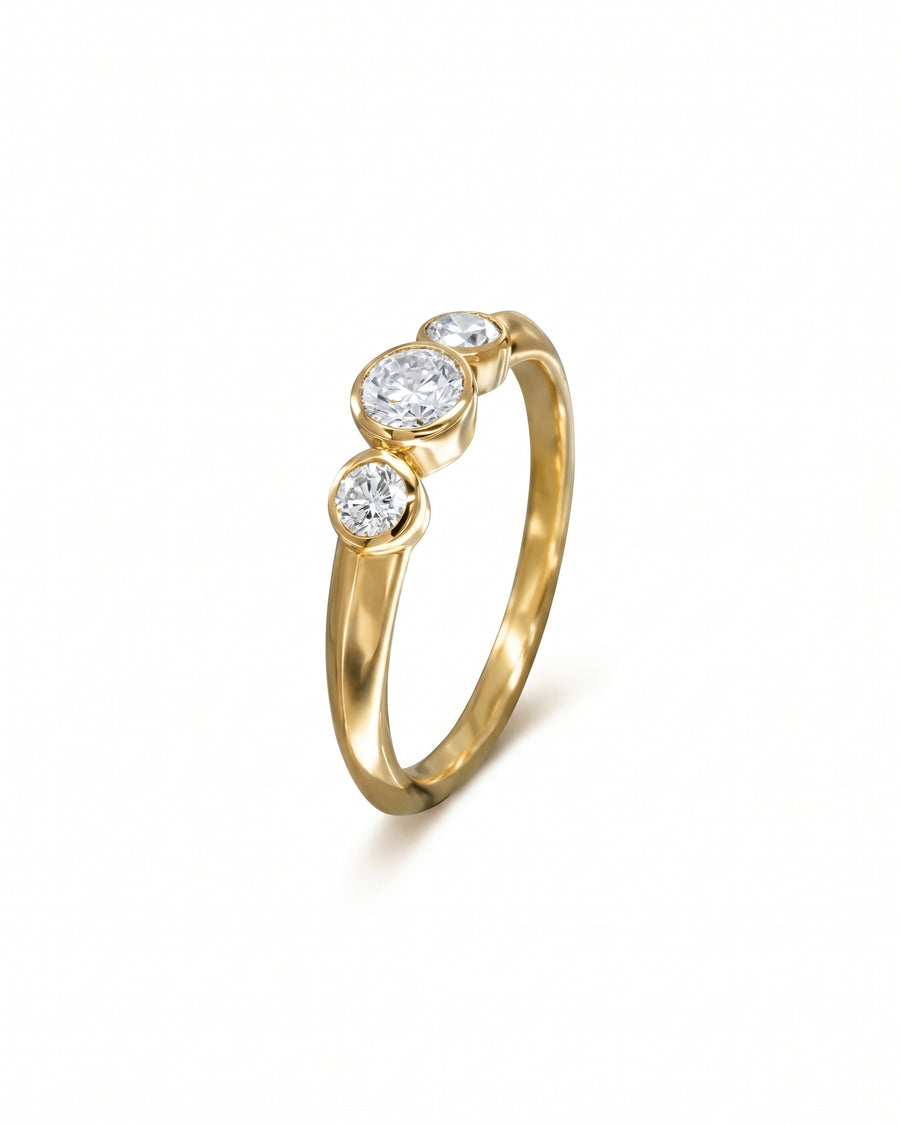 9ct gold engagement ring with three round bezel-set diamonds.