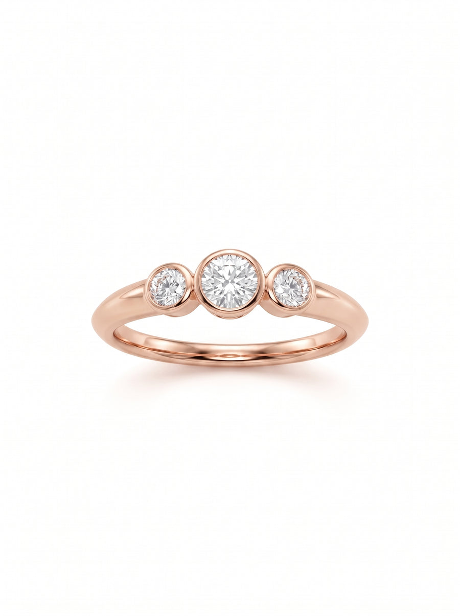 Trilogy engagement ring in 9ct rose gold featuring three bezel-set round diamonds on a polished band.