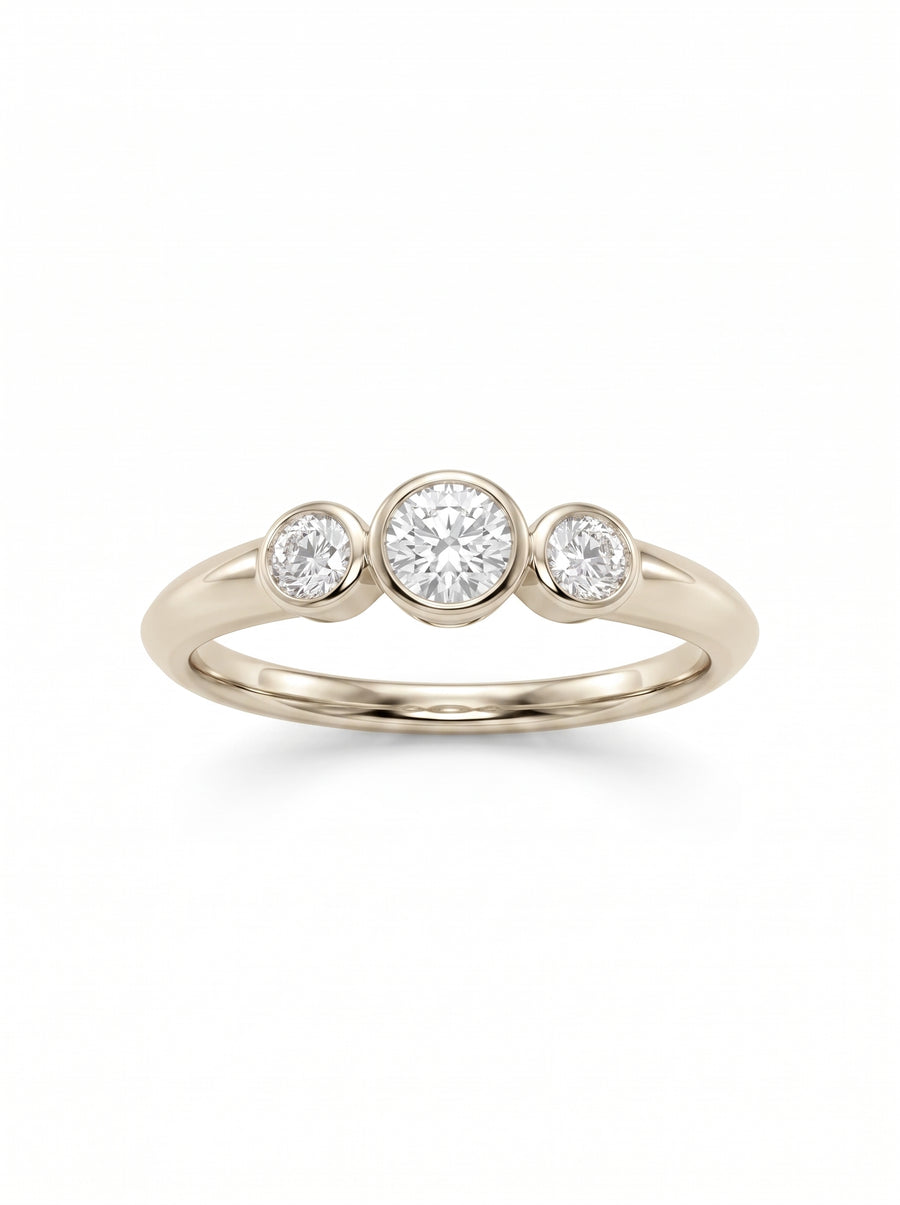 Trilogy engagement ring featuring three round diamonds in bezel settings on a 9ct white gold band.