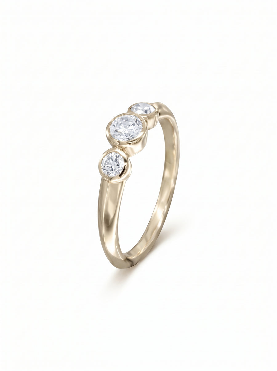 Trilogy engagement ring featuring three bezel-set diamonds on a polished 9ct gold band.
