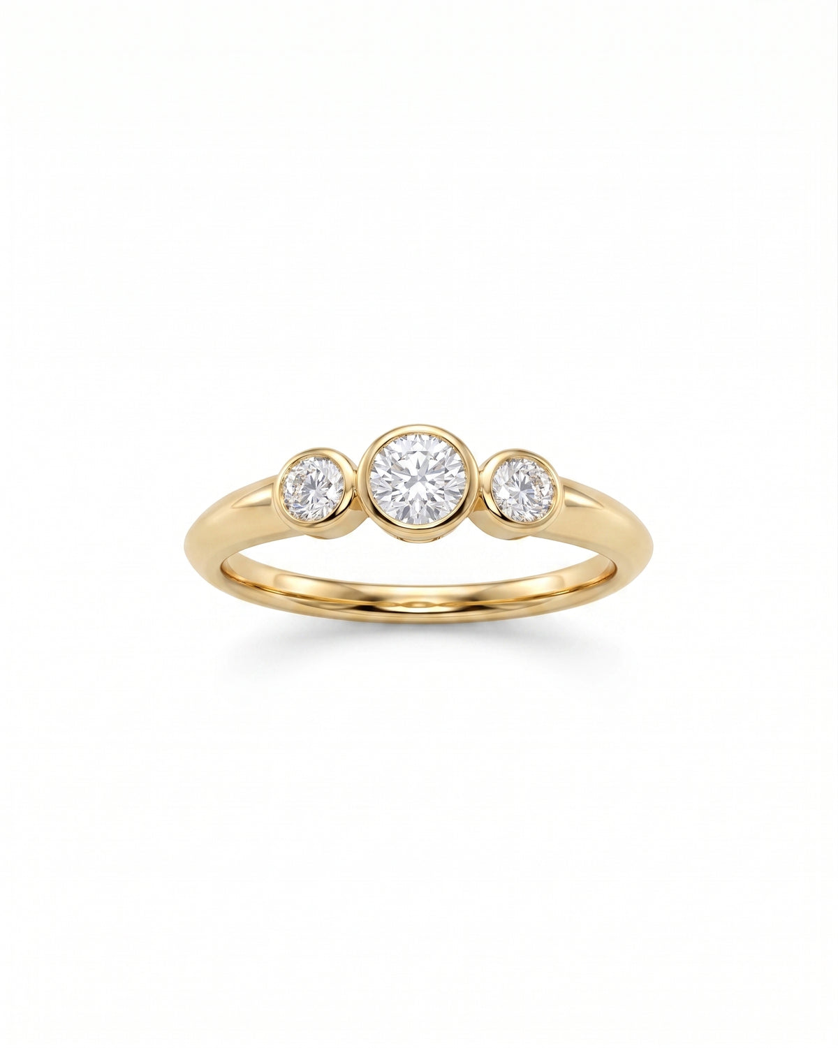 Trilogy engagement ring in 9ct yellow gold with three bezel-set round diamonds on a polished band.