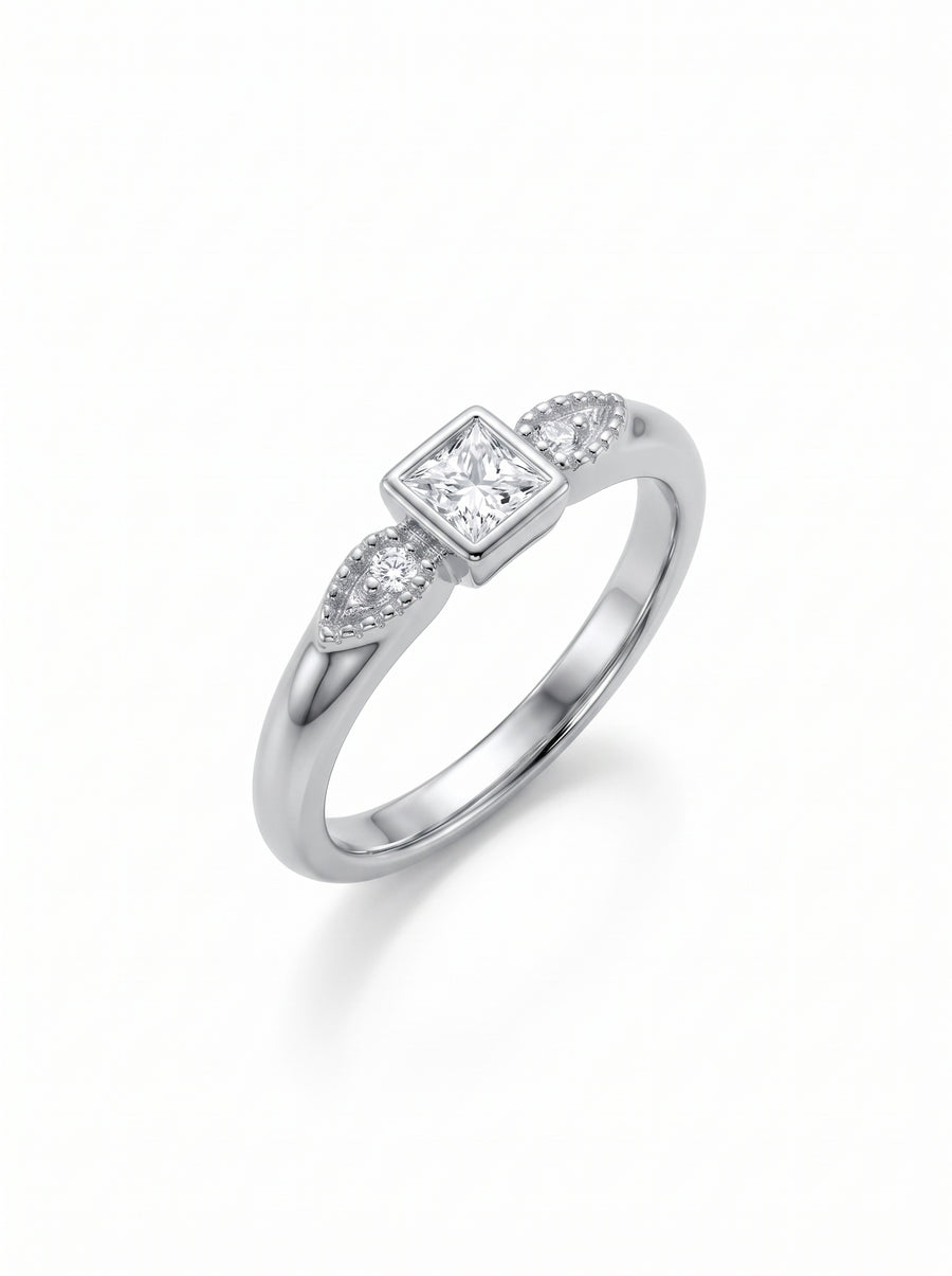 Silver engagement ring with a square princess-cut center diamond and small accent stones on a delicate band.