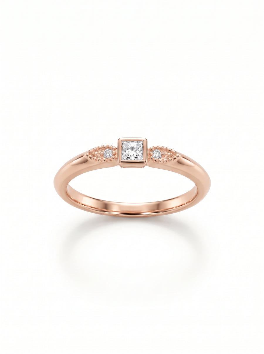 Rose gold engagement ring featuring a princess-cut center diamond and two small side stones with milgrain detail.