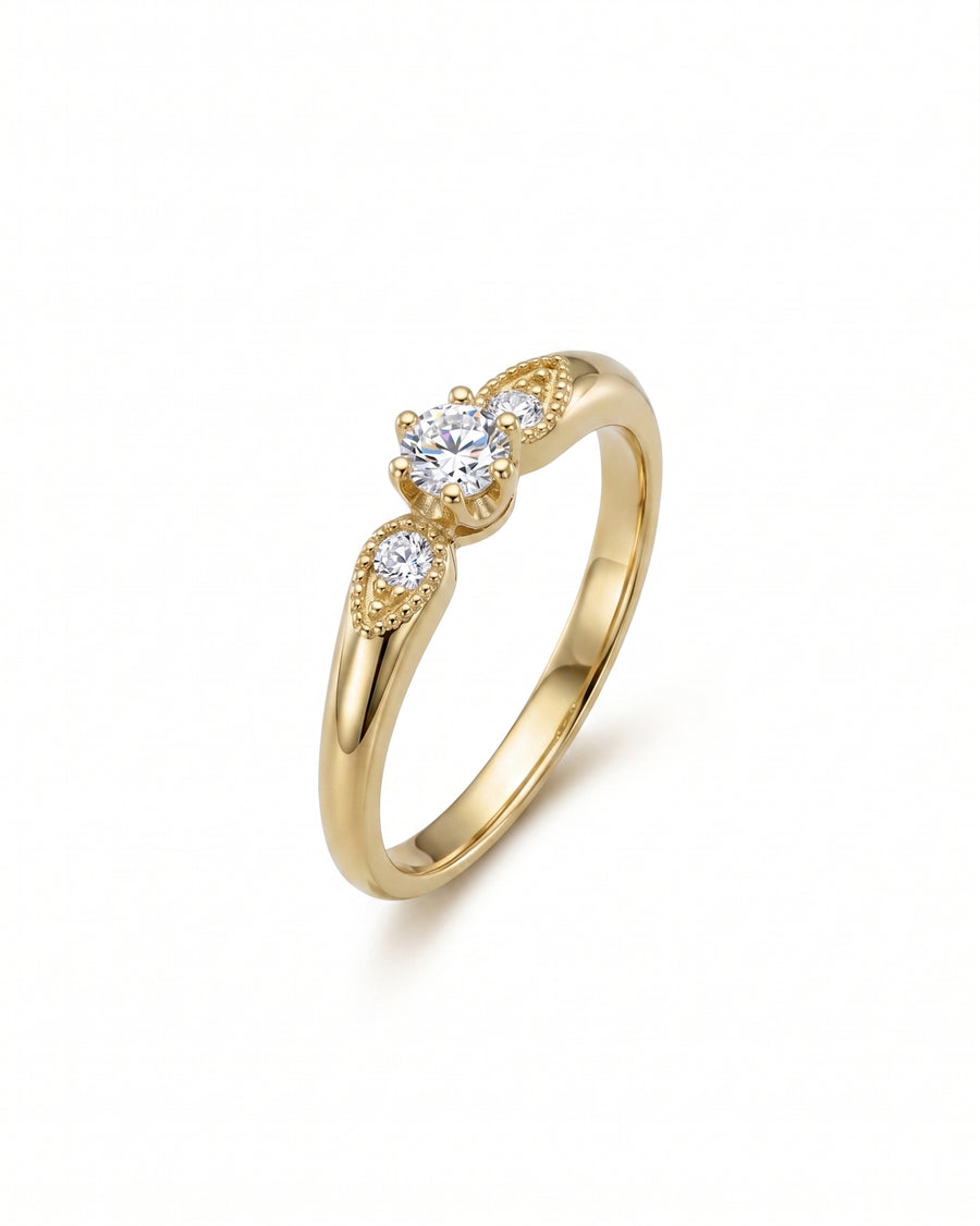 Gold vintage shoulder engagement ring with three round diamonds.
