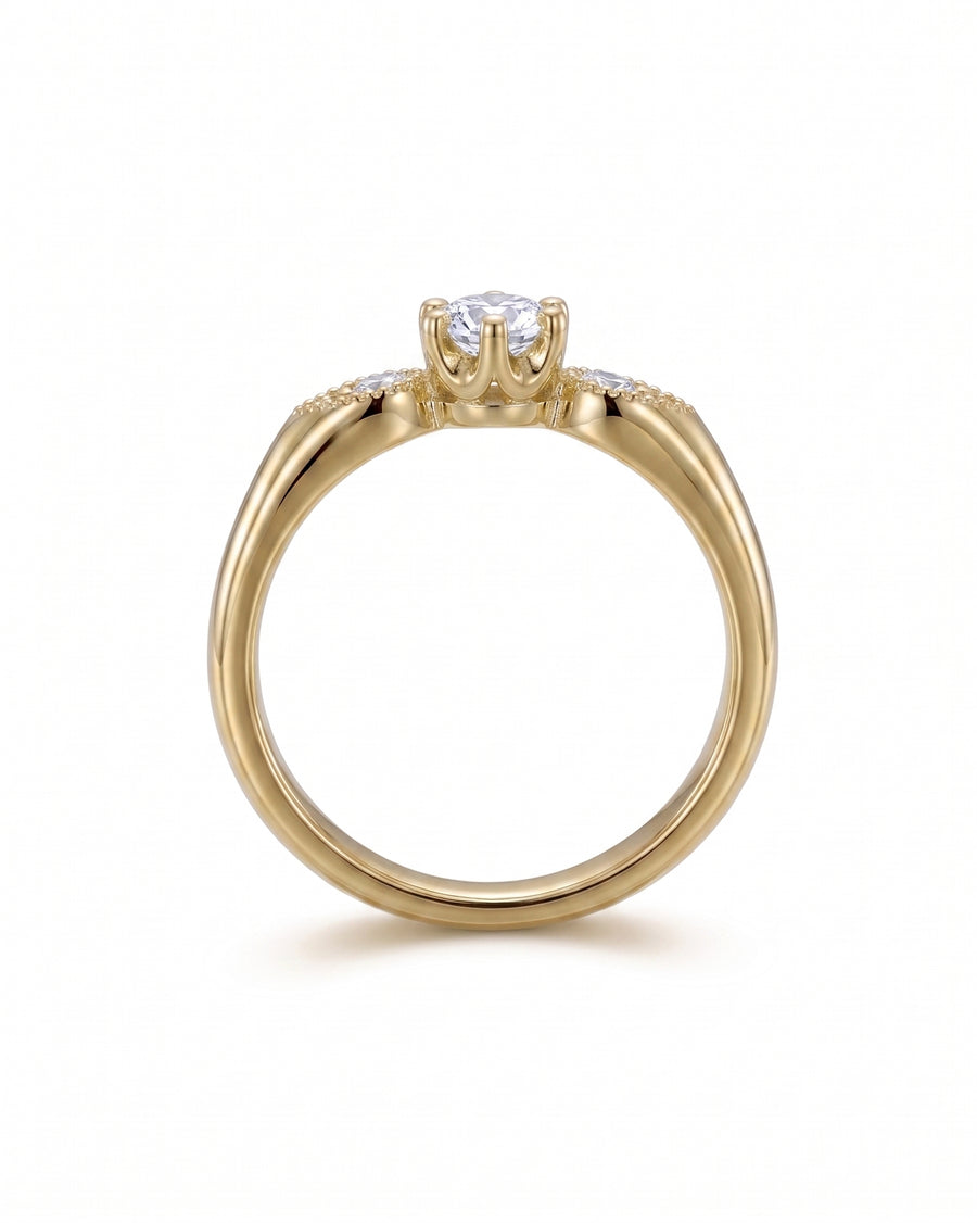 Gold vintage shoulder engagement ring with a round diamond and side stones.