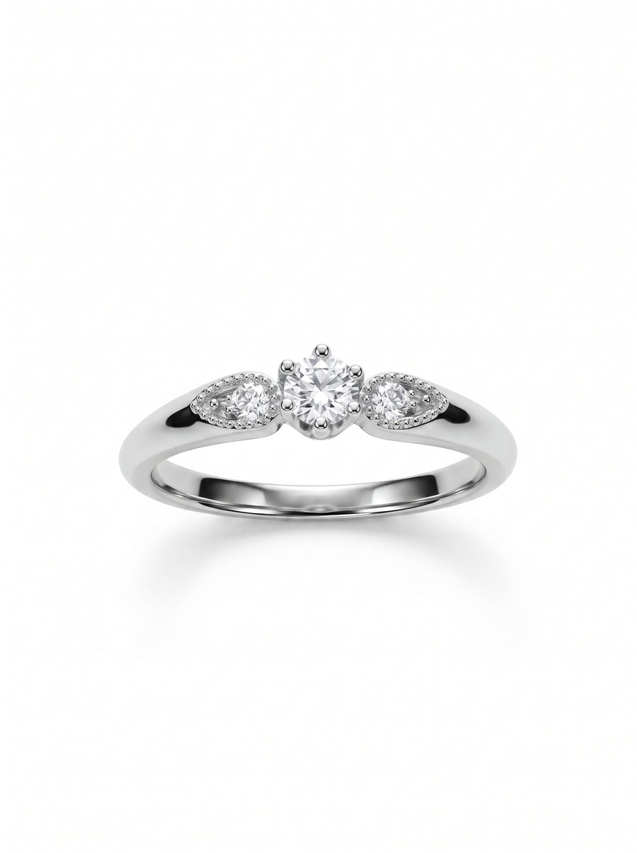 Silver three-stone engagement ring with a round center diamond and two smaller side stones in vintage settings.