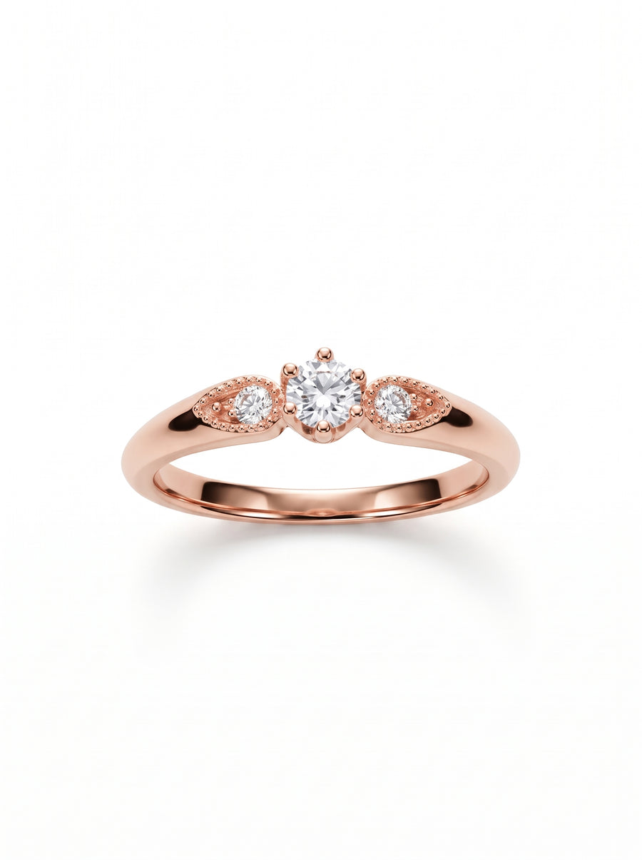 Rose gold engagement ring with a round center diamond and two smaller side stones in marquise settings.
